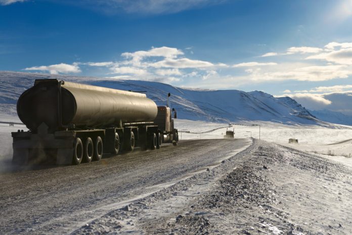 Alaska's Thriving Ice Road Oil Trucking Industry Sparks Controversy